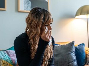 women crying in therapy session